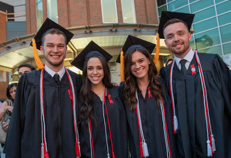 four College of Nursing graduates pose outside of the Schottenstein Center after Convocation